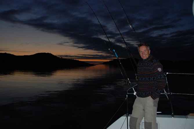 Fishing Trip with Luxury Catamaran in Tromso - Catching cod with help from the skipper