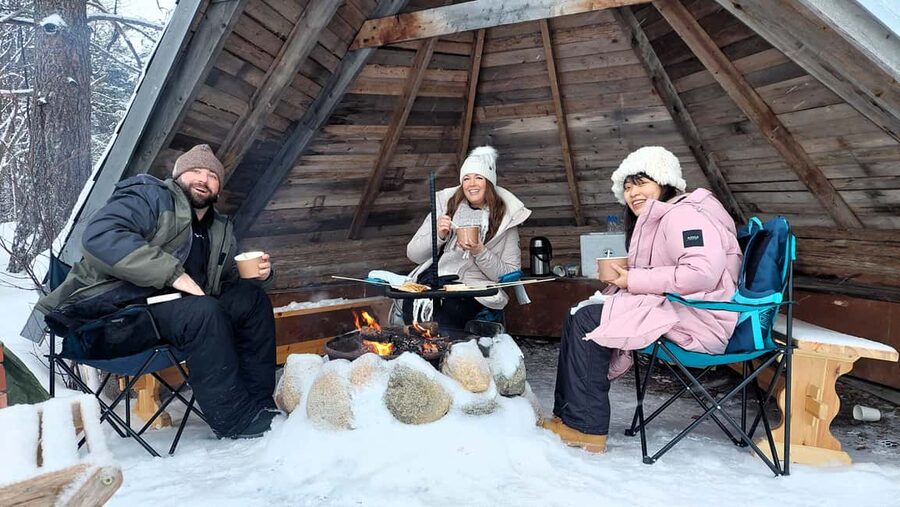 Ice Fishing Adventure in Levi with Salmon Soup - Reindeer and huskies near the fishing site