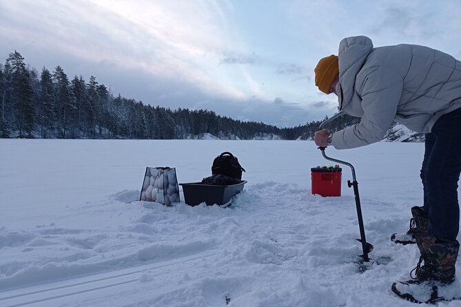 Ice fishing experience with Backpacker Helsinki Tour - Learning the basics on the frozen lake