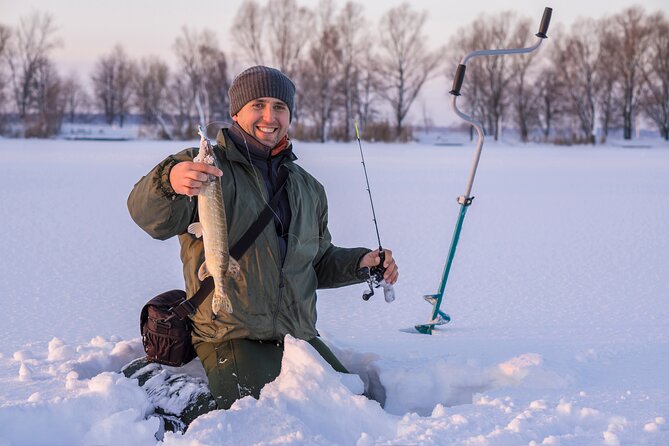 Lapland Ice Fishing Experience from Rovaniemi - Drilling through thick ice on a Finnish lake