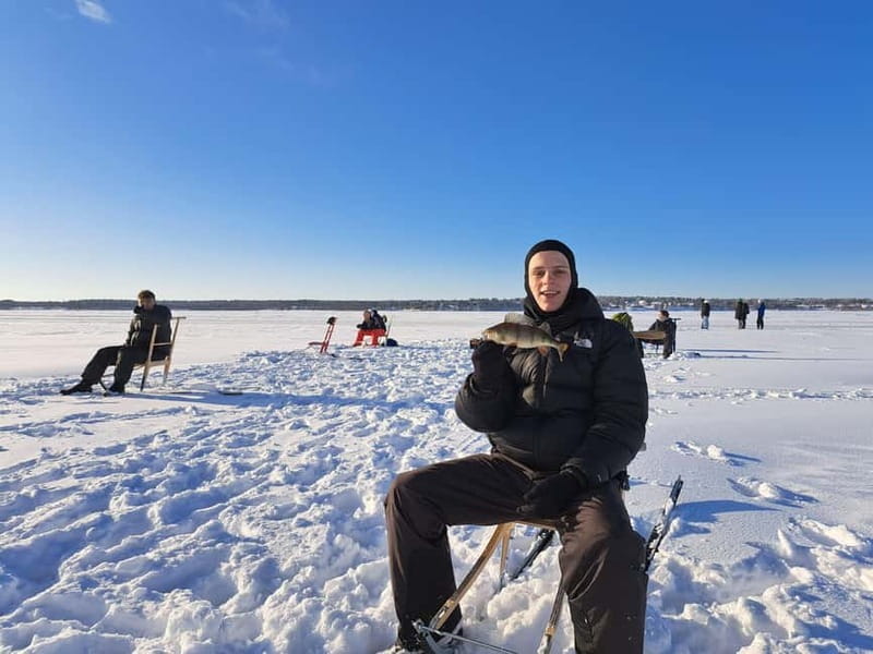 Lulea: Ice Fishing Tour in the heart of the city with Guide - Waiting on reindeer furs with a hot drink