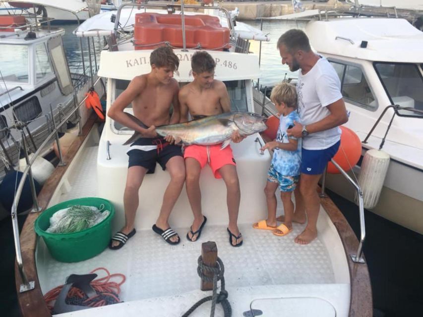 Rhodes: Captain Manolis Fishing Trip with BBQ and Swimming - Swimming near a beach, with time for snorkeling