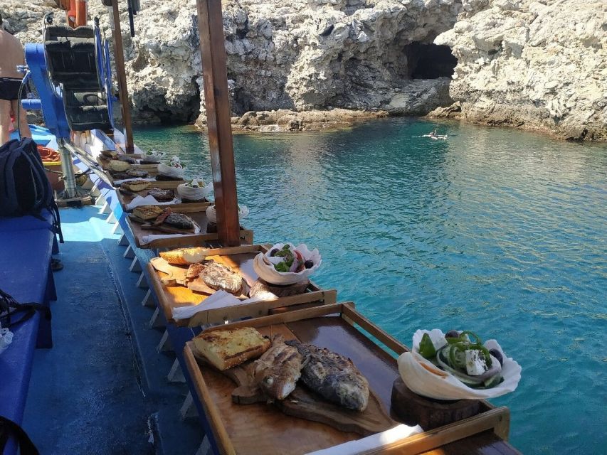 Rhodes Town: Fishing Boat Trip with Fish Meal and Swim Stops - Swim and snorkel time in a secluded cove