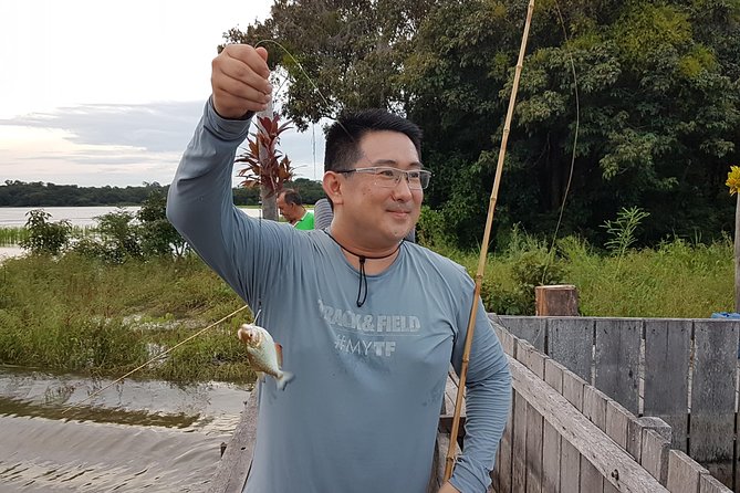 Solimoes River Piranha Fishing and Alligator Watching Tour - Fishing for piranhas beside the riverbank