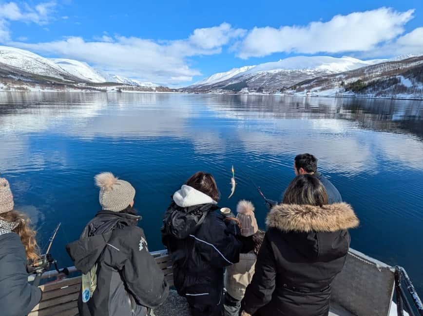 Anglers on the open deck of a fishing boat in an Arctic fjord